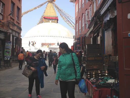 You can see the Boudhanath stupa in the background. This is one of the holiest Buddhist sites in Kathmandu, Nepal.
