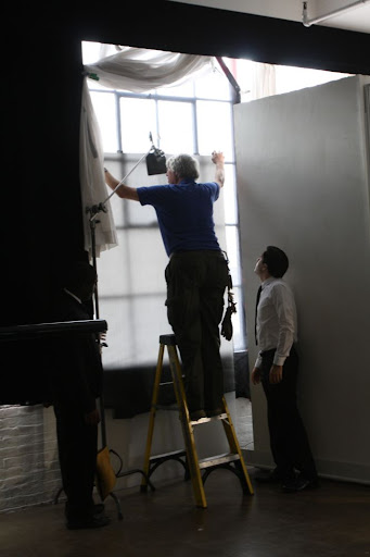 This studio space has large real windows and to soften the natural light coming in, a technician hung a large frosted panel, which acts as a diffusing scrim.