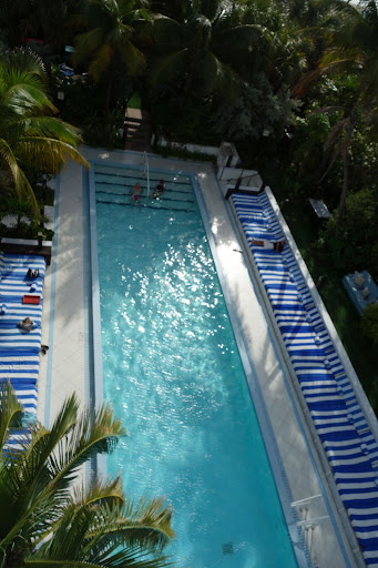 The main swimming pool is 100-feet-long and flanked by Soho Beach House’s signature striped beds and gardens.