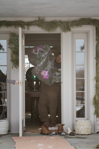The door was held open while Ryan kicked off his snow-covered boots and brought the orchid into the warmth of the house.