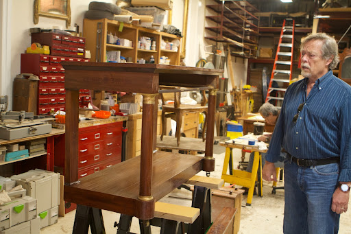 Richard explained that this console table had been bleached by the sun. Its true wood tone was discovered beneath an ornate drawer pull. The bleached finish will be returned to that original stain.