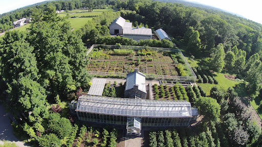 A great shot of the main greenhouse in the foreground - also distorted by the wide angle lens, flower garden behind it and the equipment shed, vegetable greenhouse and hay barn in the back. Then notice the structure in the top left of the photo...