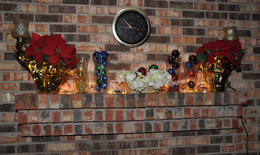 Christine Brown from Fittstown, OK was inspired to decorate her fireplace mantle using pointsettia garland, candles, and white lights.
