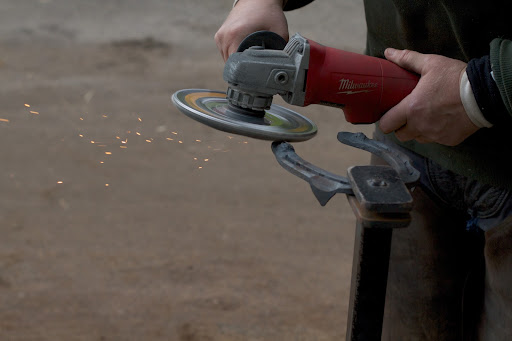 Next, an angle grinder smooths out rough areas.