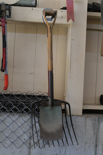 Tools are hung so that they are easy to find. Dirt is rinsed off outdoors before tools are put away.