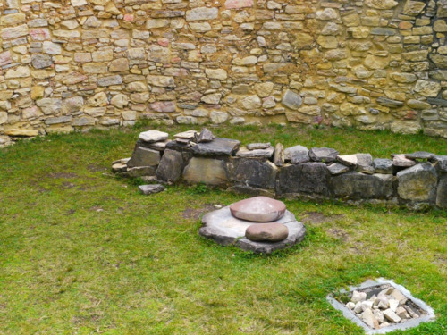 The inside of a typical circular home - a stone for grinding corn and a hole right inside to bury your family members - plus a tunnel to keep qui, or delicious guinea pigs!