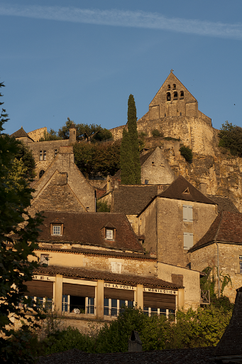 A view of the perfectly preserved medieval village of Beynac - golden in the evening sun