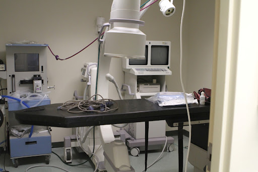 This is a Fluoroscope, a type of X-ray machine that combines an X-ray source and a fluorescent screen to enable direct observation of an organ while it is functioning.
