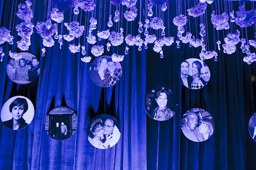 Along with flowers, photos of friends and family also hung from the ceiling. Photo credit: Mel Barlow