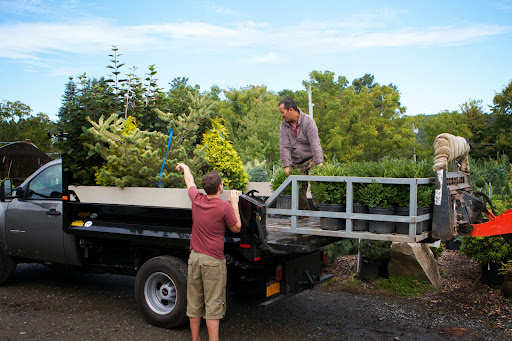 Realizing that there wasn't enough room on the trucks for all of the plants and a second trip would have to be made, Ryan and Chhiring discussed the details.