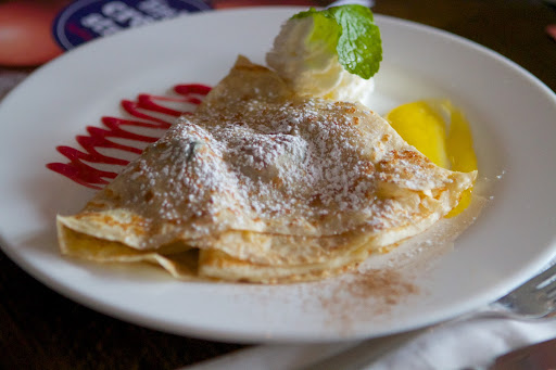 A sweet crêpe of lemon curd, fresh blueberries, and raspberries