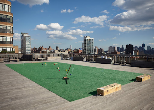This abbreviated court was set up for timed 15-minute multiple games. American Croquet is played between two sides - the blue and black balls versus the red and yellow balls. Photo credit: Anna Ross