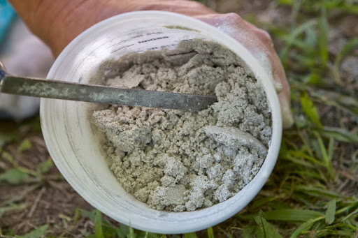 She mixed up a batch of lime mortar, which is lime and an aggregate such as sand, mixed with water. It's one of the oldest known types of mortar, dating back to the 4th century BC and was used extensively in Ancient Rome and Greece.
