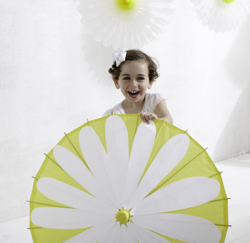 Buy the parasol from Opensky and then learn how to embellish it here:
http://www.marthastewart.com/295412/posy-parasol