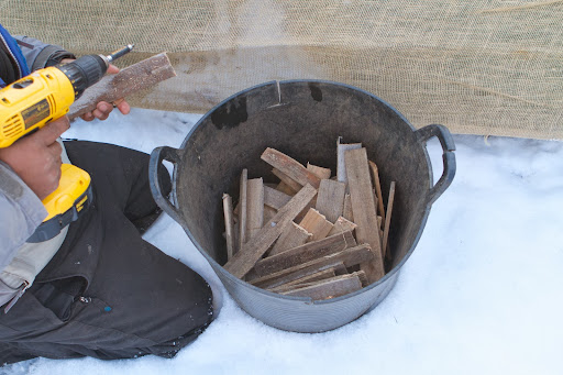 Pete was in charge of anchoring the burlap to the bottom of the frame. To do so, he used these wooden strips.