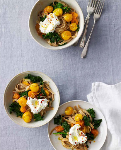 Golden-Tomato and Kale Pasta - Bright green blanched kale and sautéed Sun Gold tomatoes add bursts of color and sweetness to whole-wheat fettuccine, which is finished off with ricotta, a drizzle of olive oil, and a sprinkle of chile flakes.