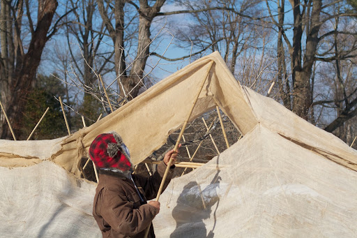 After all the framework was completed, the next step was to begin draping the long lengths of burlap over the bamboo.