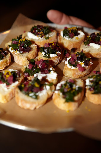 In addition to pizza, the menu also features 'toasts.' Here is a tray of toasts topped with Swiss chard and ricotta.