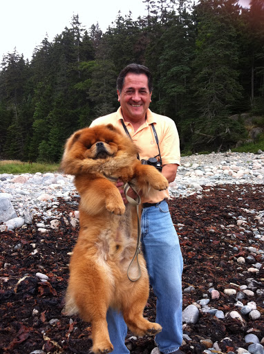 Uncle Carlos helped G.K. across the beach rocks to flat terrain.