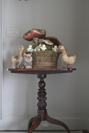 This woodland scene is arranged on another entrance hall table - lichen and moss-covered toad stools, ducks, and a Lionhead bunny.