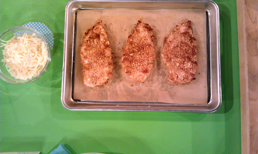 The chicken is baked until crisp and brown and is served with a side of whole-wheat spaghetti, tomato sauce, and melted part-skim mozzarella. 389 calories per serving