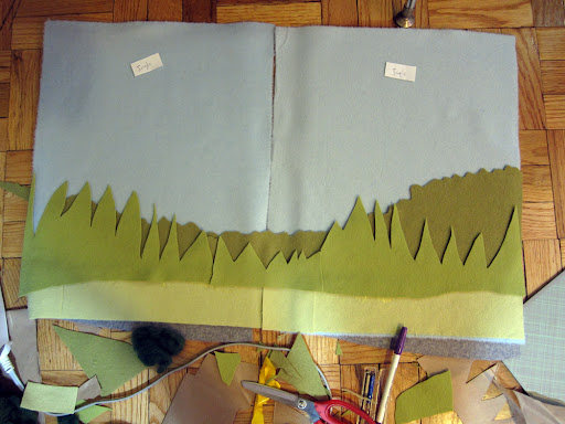 Laying out the background of the jungle with felted wool fabric - If you wash wool fabric in hot water, the fibers fuse together and become 'felted.'