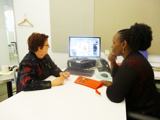 Here she is meeting with Kate Lewis - AVP, Dir. of Standards - reviewing the Sanabora Design House Web site. The orange clutch is one of Beatrice's designs. You may recall, from previous blogs, that Kate is quite involved with women empowering women organizations.