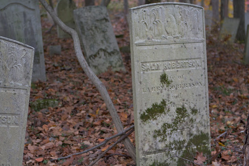 This headstone was adorned with weeping willow trees, which symbolize mourning and grief.
