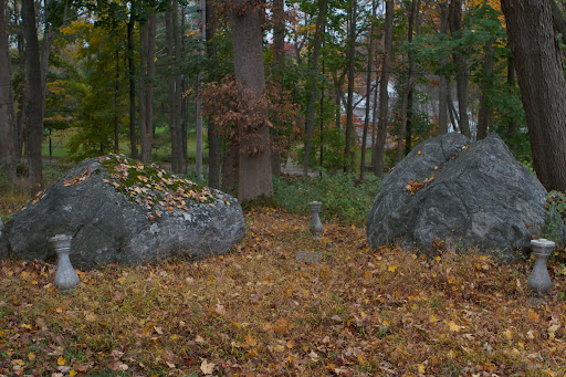 It is believed that Chief Katonah is buried beneath the large boulder and that Squaw Cantitoe and their son are buried beneath the other.