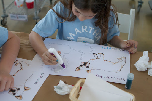 Lauren applyed a thin line of glue to the edges of Sharkey's skirt, where she then applied some blue Martha Stewart brand glitter.