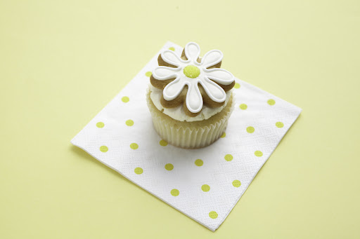 The cookies are frosted with royal icing and the centers sparkle with yellow sanding sugar. This idea can be adapted with many other shaped cookies for whatever theme your party is.