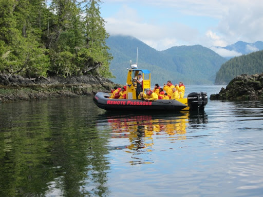 Another group of whale watchers wearing yellow jumpsuits.