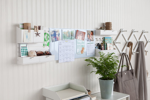 This entry way set up incorporates drawers and caddies along with magnetic boards to shared schedules and reminders.