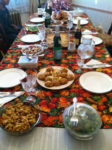 Ashlee Romain - Our dinner table topped with homemade stuffing, broccoli, baked mac-and-cheese, roasted red potatoes, turkey, sliced sweet potatoes, cranberry, filet mignon, and avocado salad