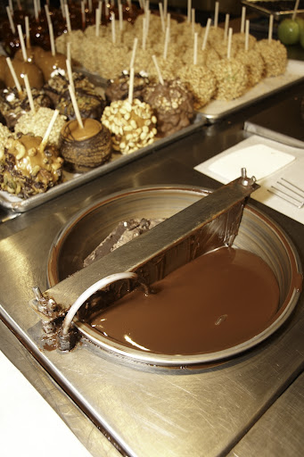 The next step is to dip the apples in Belgian Chocolate. Amy’s uses dark chocolate, milk chocolate, and white chocolate.