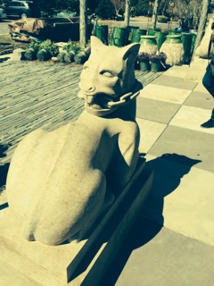 The vein of its neck is pronounced and suggests the power of the beast watching over the entrance.