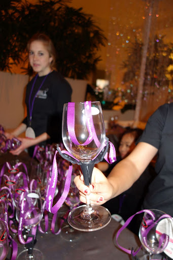 The wineglasses are in a holder and are designed to be worn around the neck.