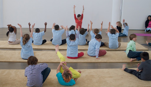 Moving into some forward bending as they neared the end of the 45-minute class - Here they are getting ready to move into is janu sirsasana, or head-to-knee pose.