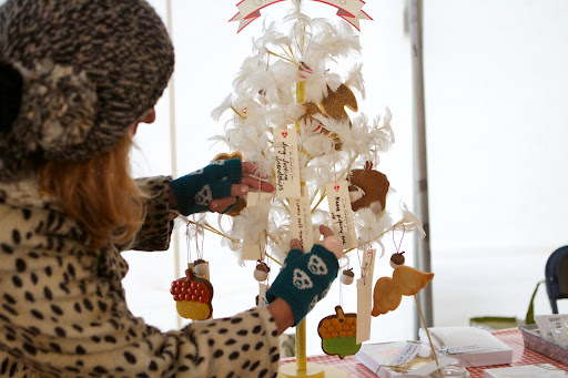 In her booth, Dani decorated a feather tree with her treats. She asked her customers to write down what they were thankful for and she hung those thoughts on the tree.