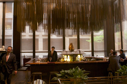 In the bar area, thousands of brass rods hang from the ceiling to produce, what is called a 'sculptured chandelier' effect. The Grill Room has always been the place for New York City's 'power lunches,' attracting a who's who of moguls, politicians, socialites, models, philanthropists, architects, and journalists.