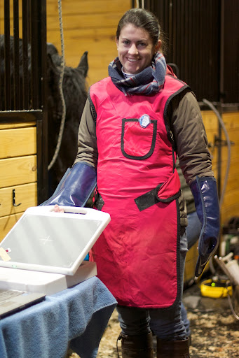 Kerri, another vet, helped with the x-ray. She wore a special body smock and gloves to shield herself from harmful rays.