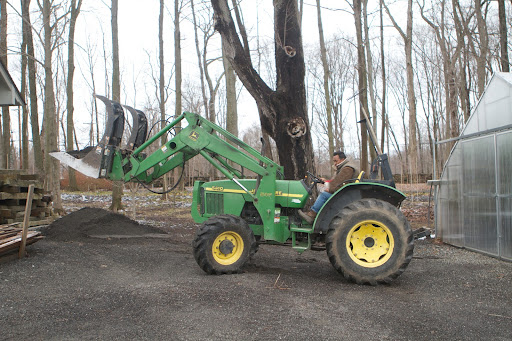 To repair those potholes, we keep a supply of pea gravel on hand. Here is Pete getting a load of gravel.