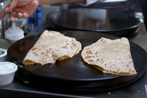 The crêpes are folded over and the fillings warmed through.