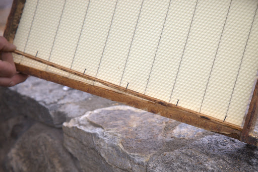 A strip of wood is added to secure the wax.