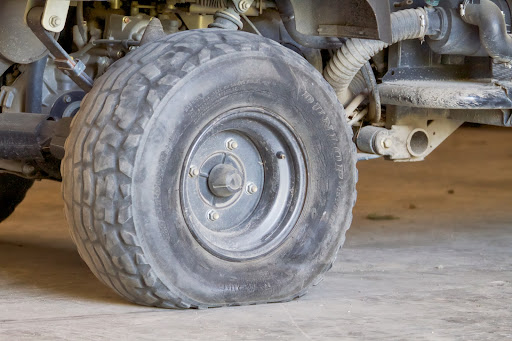 Driving around the farm, one of the Kawasakis suffered a flat tire. It was brought to the equipment shed for repair.