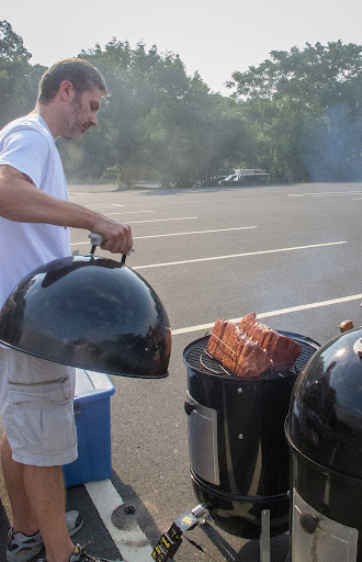 Gregg put the ribs onto the smoker. While teams only need to turn in 6 pieces, they usually cook more so they can pick the best of the batch. This smoker has another wire rack with more ribs inside.