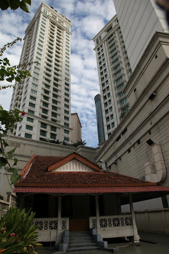 This is Malaysia's capital, Kuala Lampur, with one of the few examples of a tiny traditional colonial house still standing amidst the tall skyscrapers.