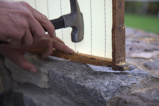 The strip is carefully nailed in place.