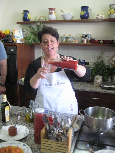 Chiara explained the importance of finding a good local tomato sauce that's not too acidic, while giving the students a taste of their homemade sauce.