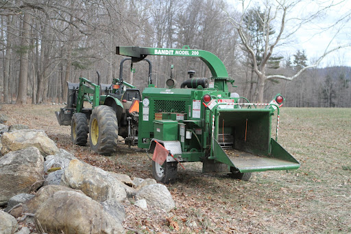 All of the branches are being dragged out of the woods and fed into this wood chipper, which has also been working overtime. The wood chips are blown right back into the woods, where they will eventually decompose.